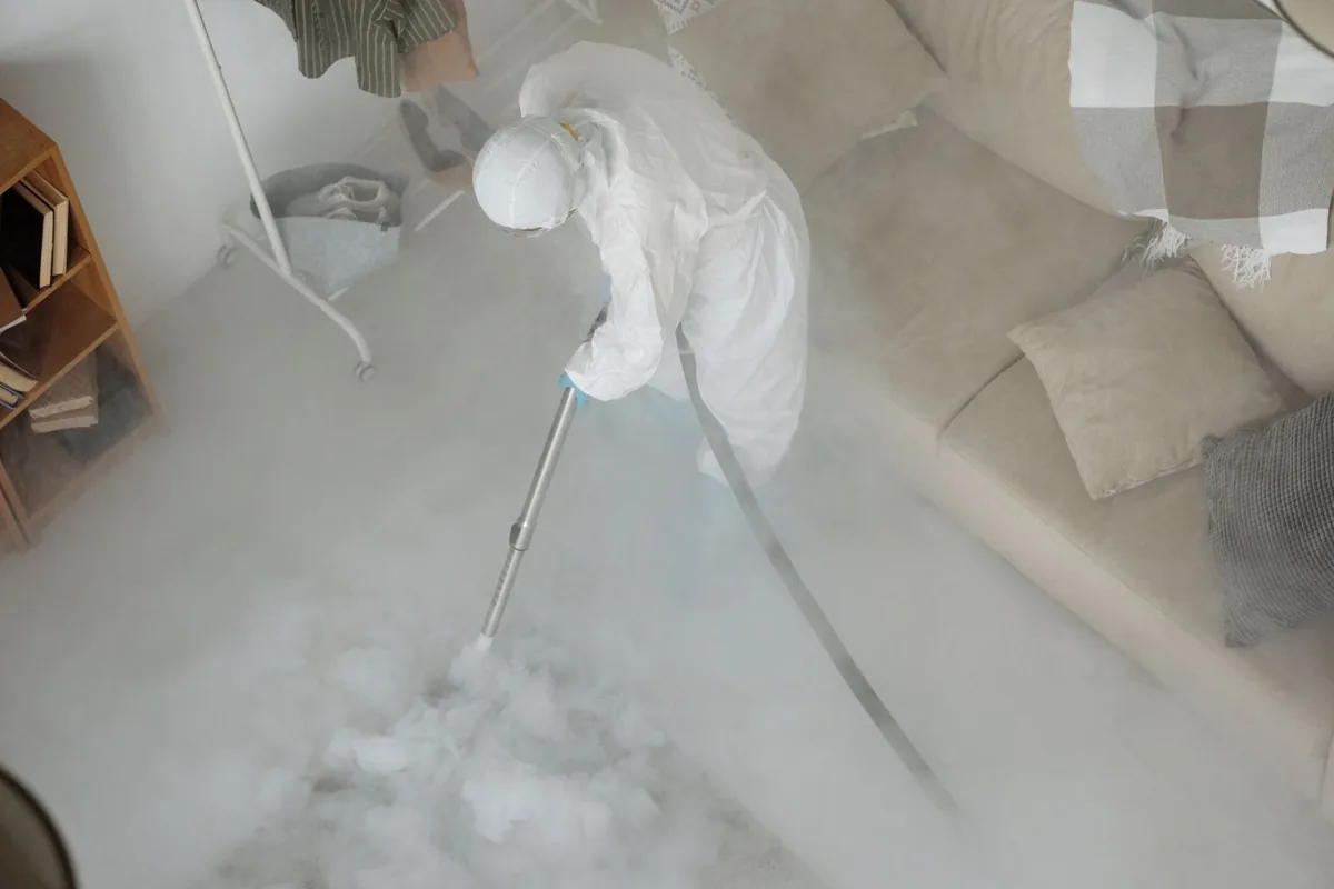 Biohazard cleanup technician in protective equipment, Odessa, MO